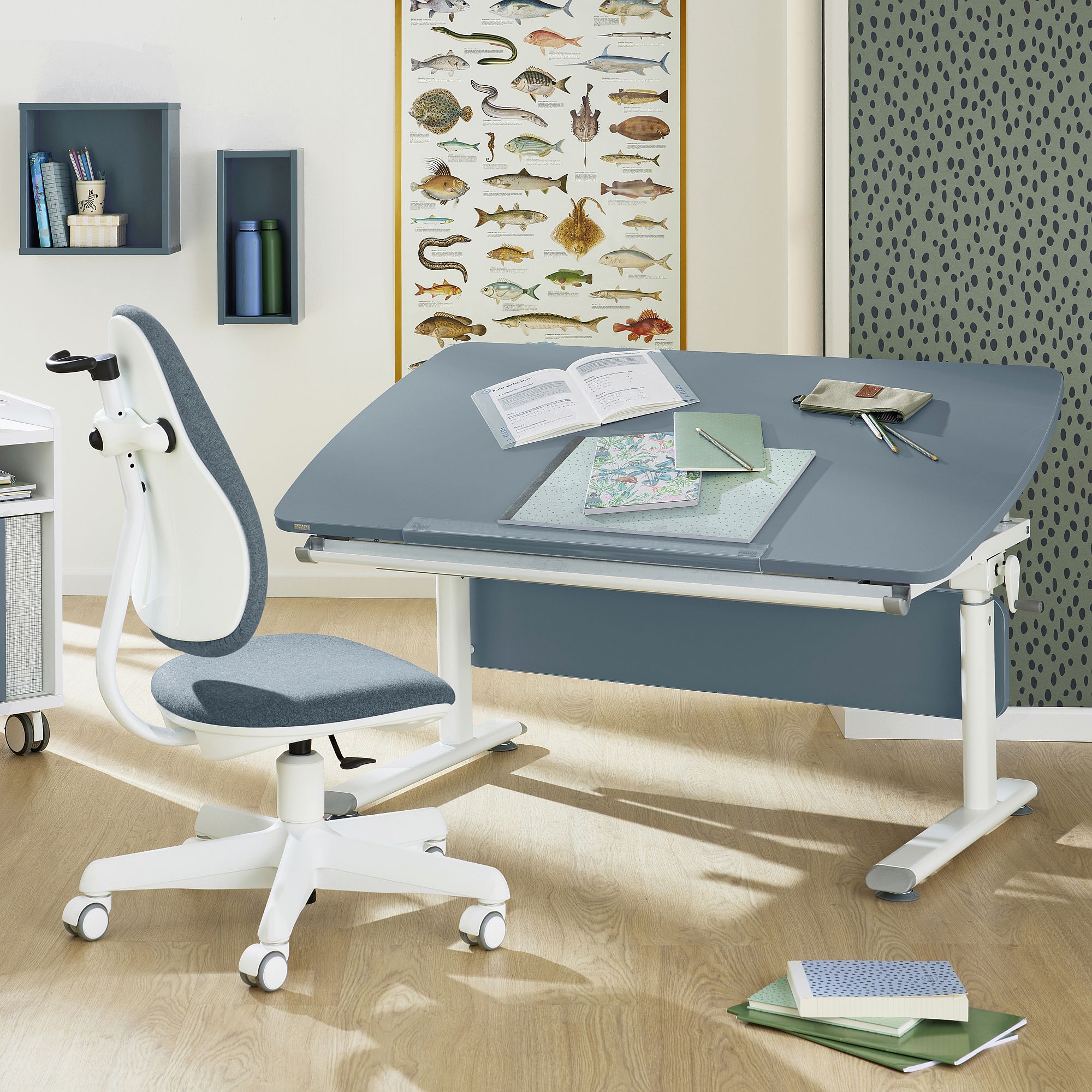 Modern study desk with books, chair, and fish poster on the wall behind.