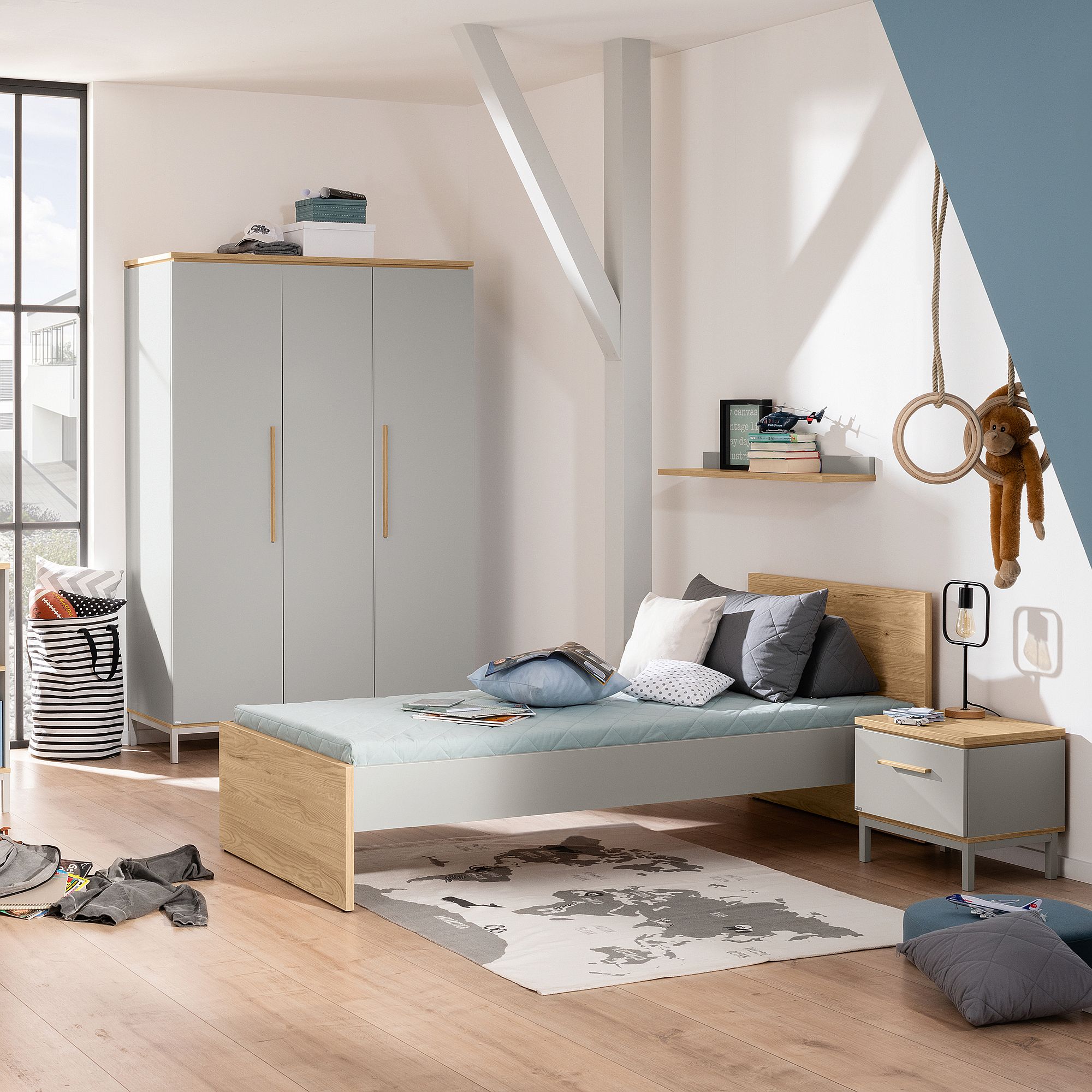 Ein modernes Schlafzimmer mit einem Einzelbett, einem Kleiderschrank und auf dem Boden verstreutem Spielzeug.