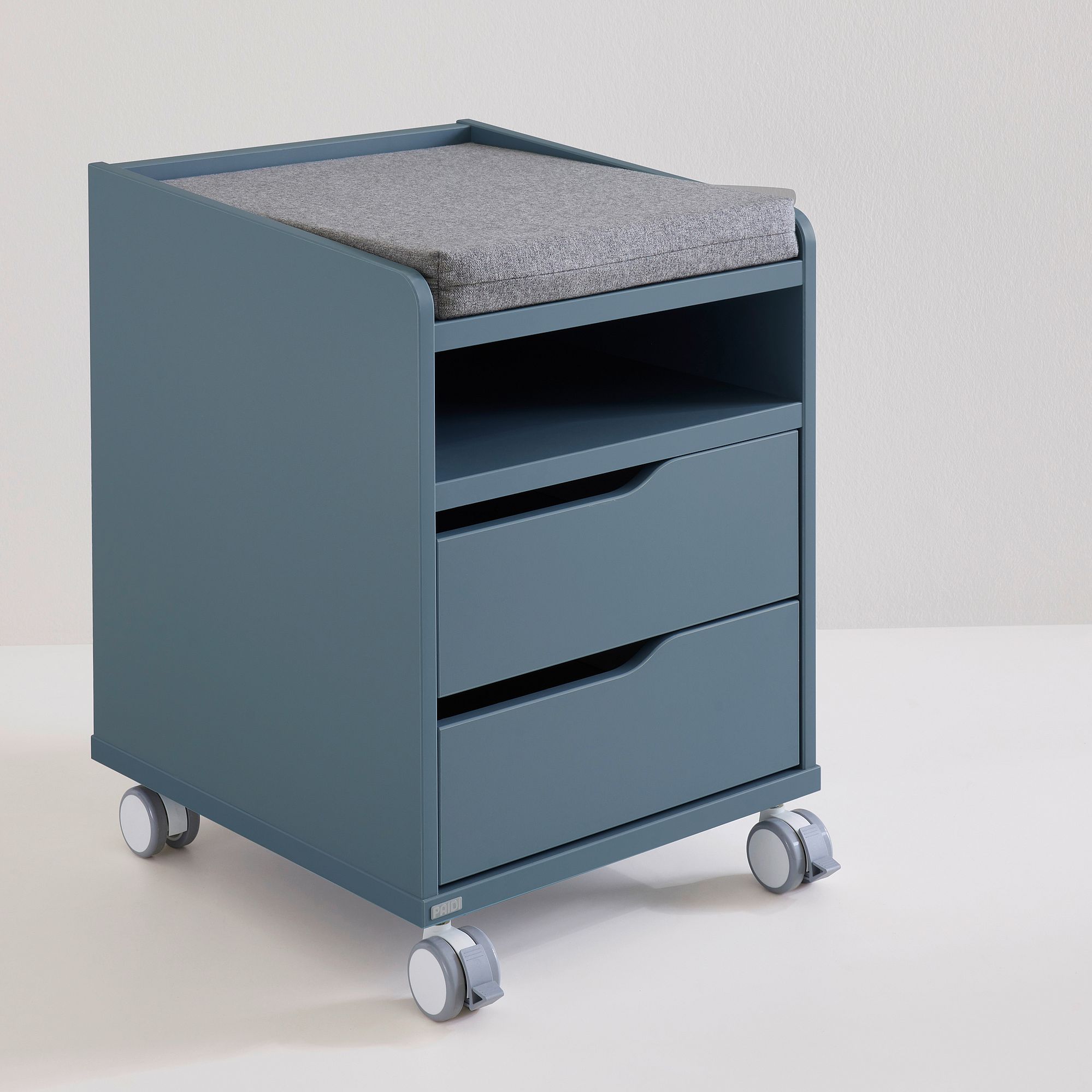 Rollcontainer  mit 2 Schubladen in Mattblau Blauer Rollwagen mit Polsterauflage, offenem Regal und zwei Schubladen.