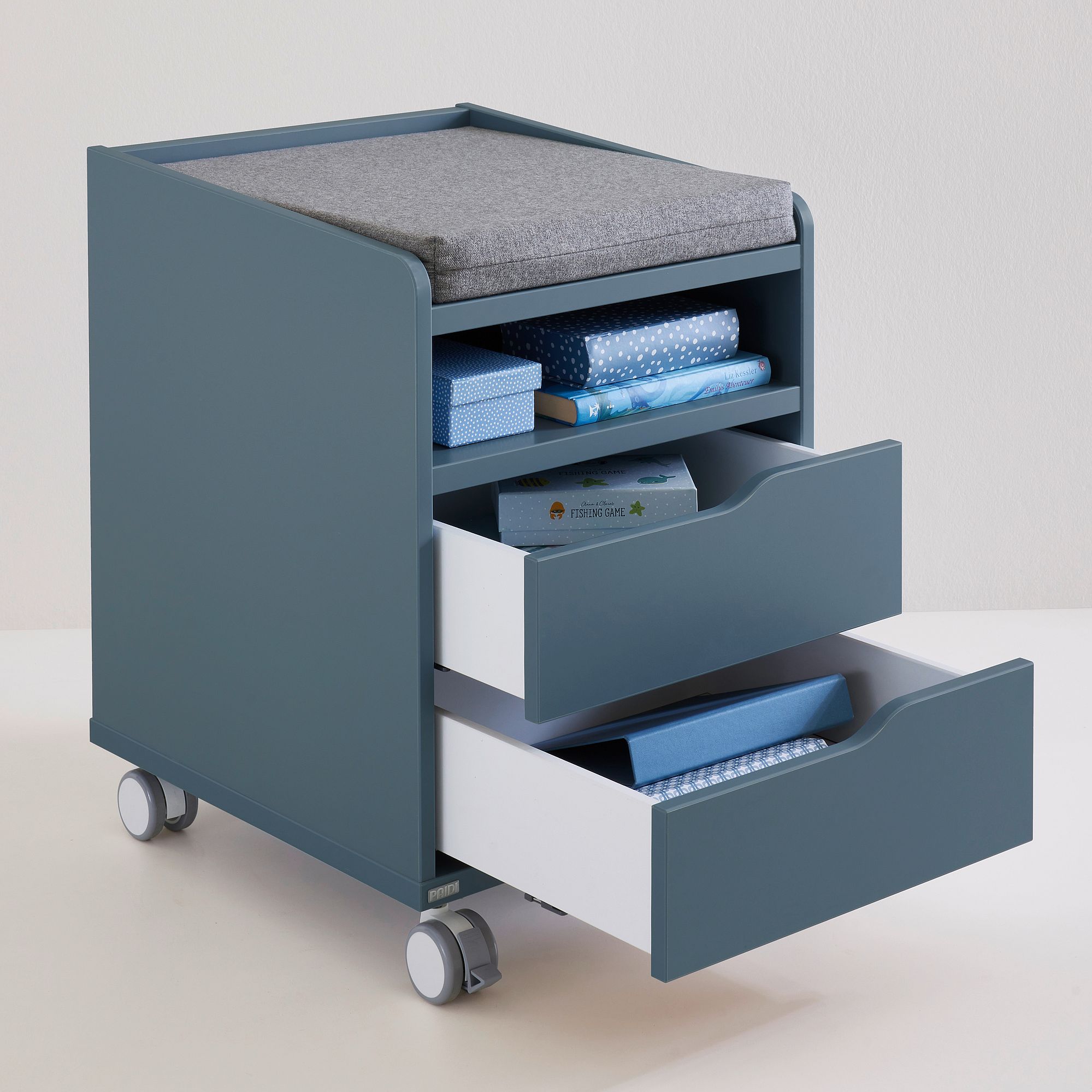 Rollcontainer  mit 2 Schubladen in Mattblau Blaue rollende Aufbewahrungseinheit mit geöffneten Schubladen, die gefaltete Stoffe und Schachteln aufnehmen.