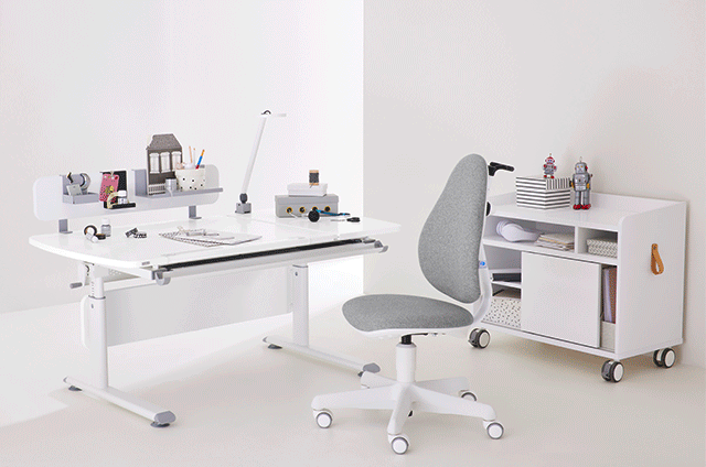 Modern white desk and chair set with organized shelves and accessories in a minimal, bright room.