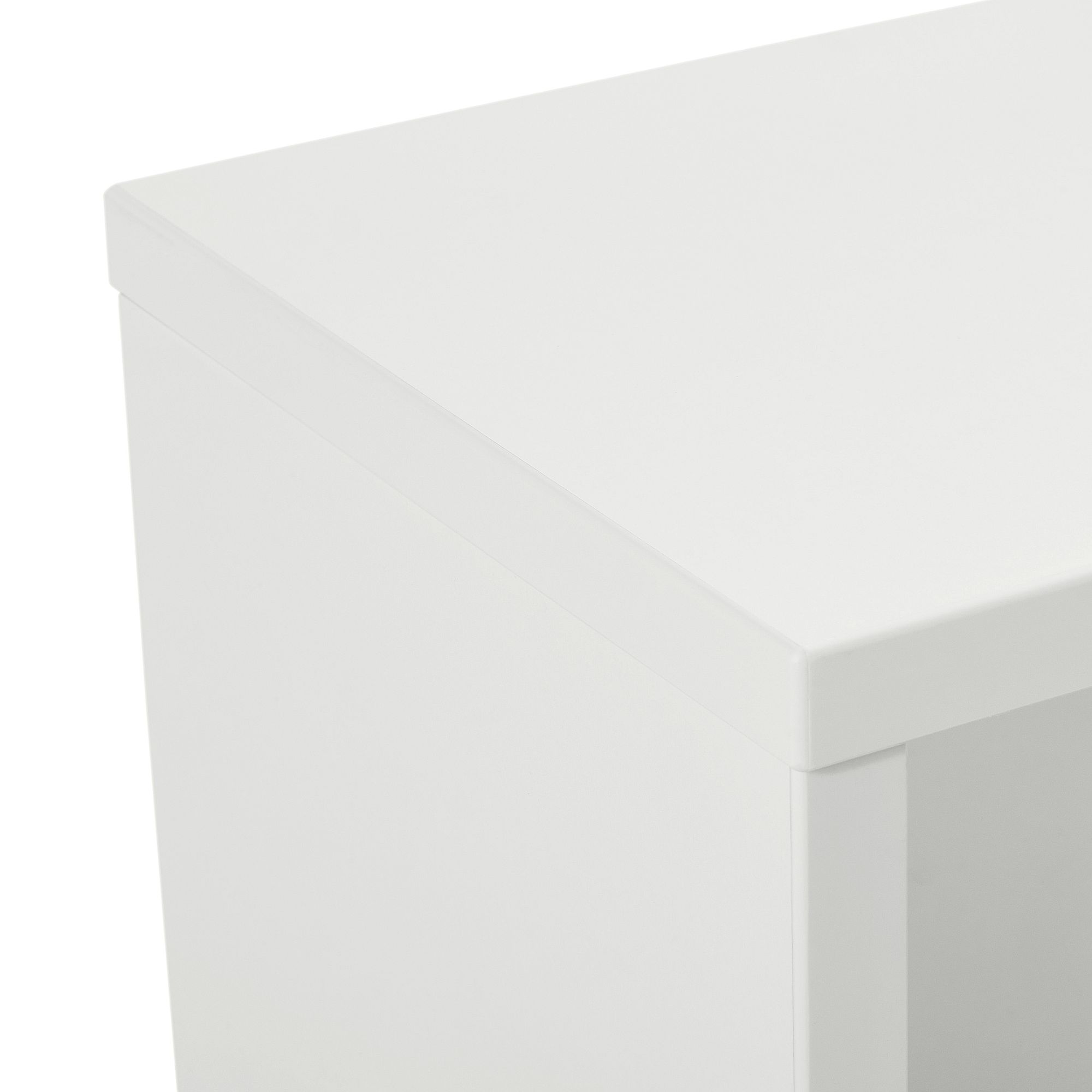 Close-up of the top corner of a white rectangular cabinet or table.