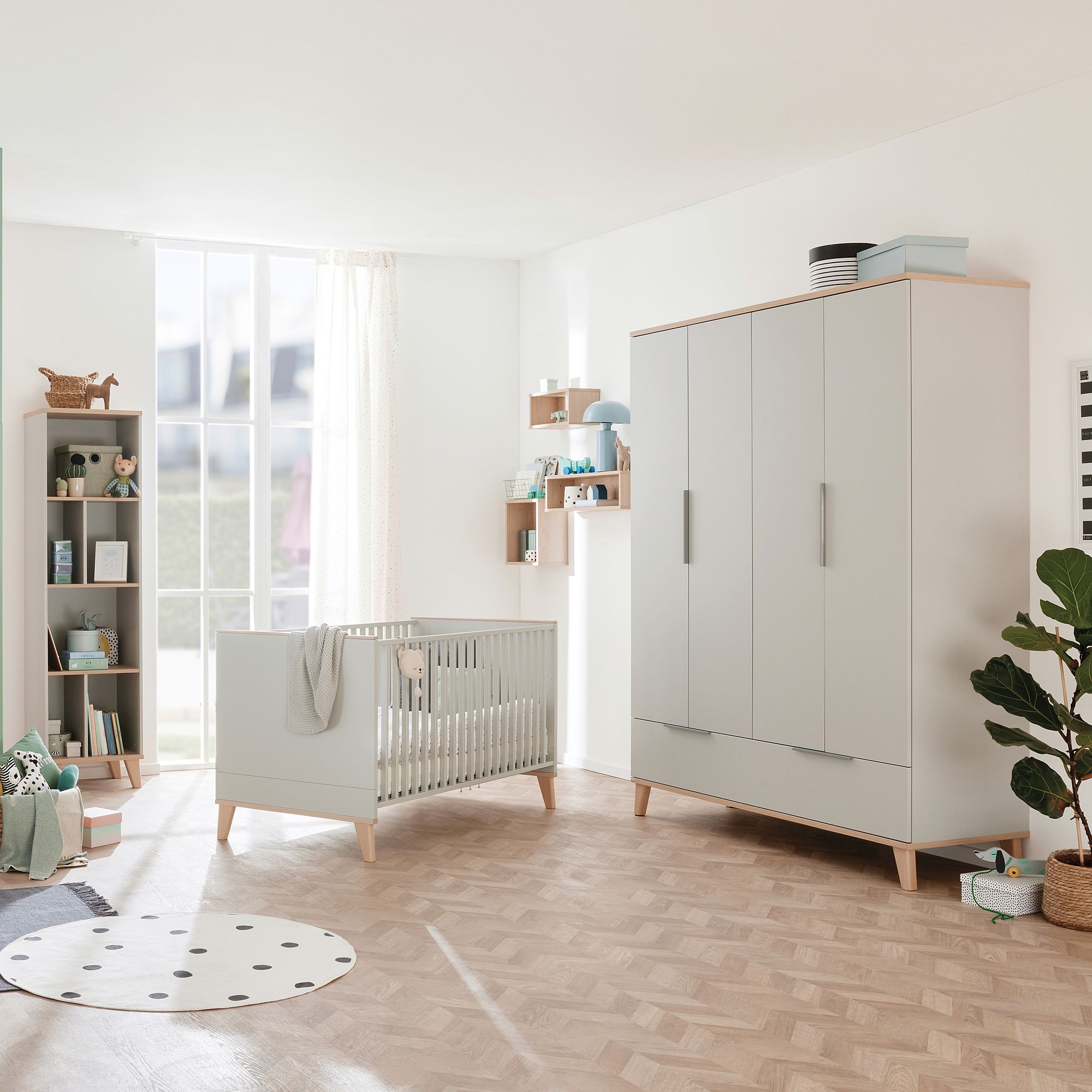 Modern nursery room with a crib, wardrobe, shelves, and natural light.