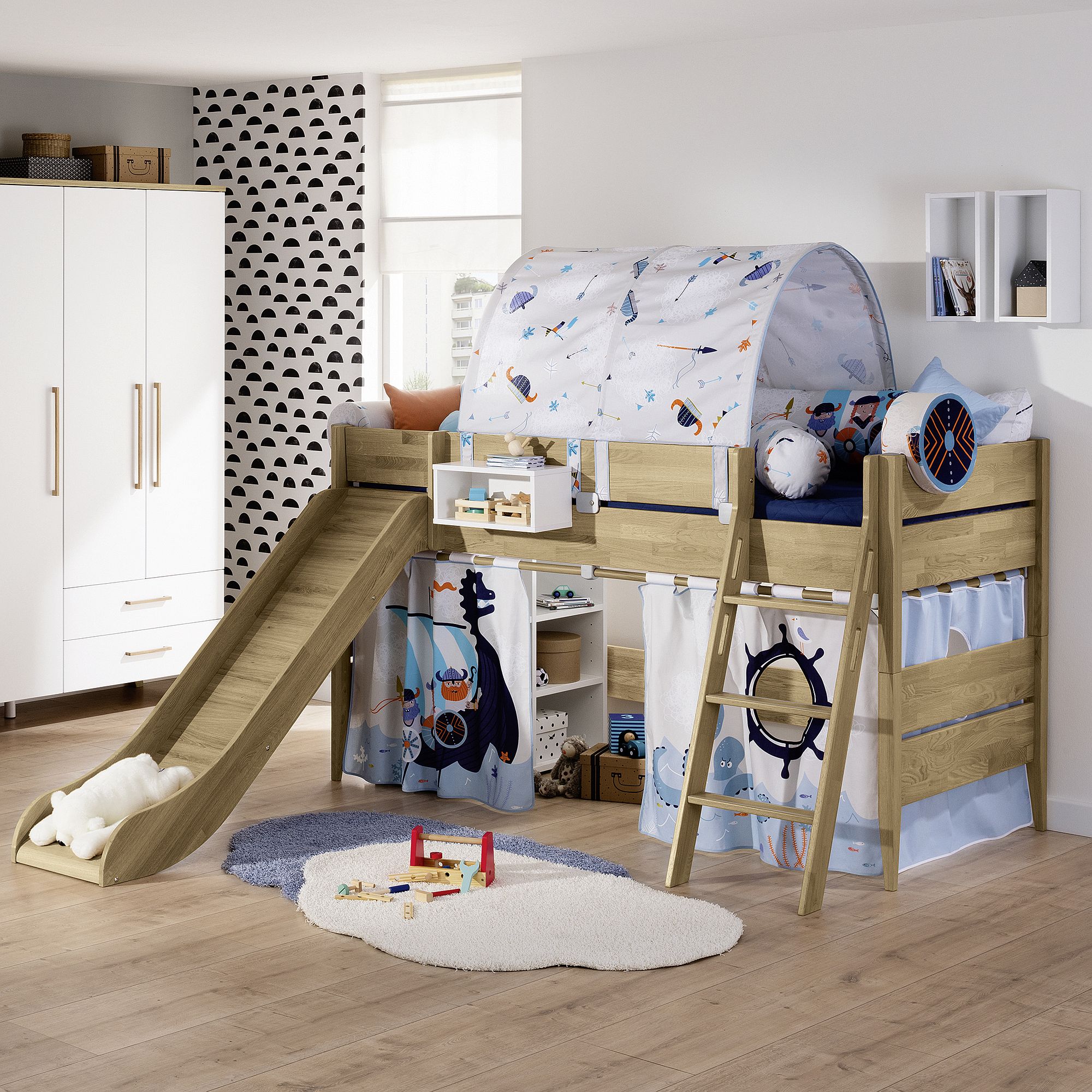Children’s loft bed with slide, ladder, play tent, and nautical-themed decor.