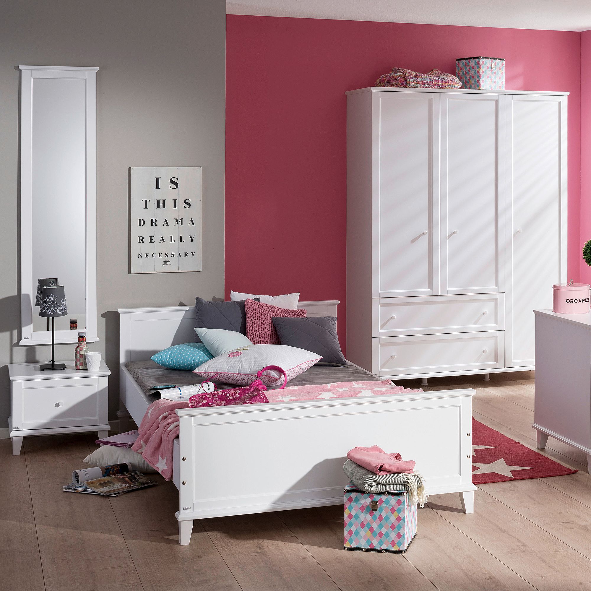 A modern bedroom with white furniture, pink accents, and decorative pillows.