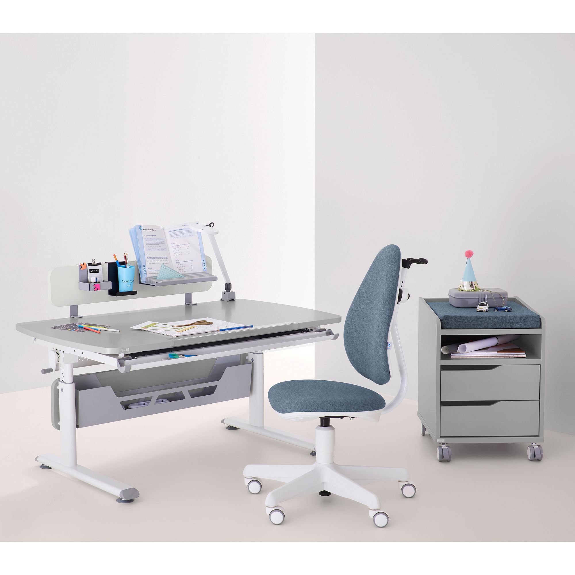 Modern study desk with blue chair, books, and stationery on a gray background.