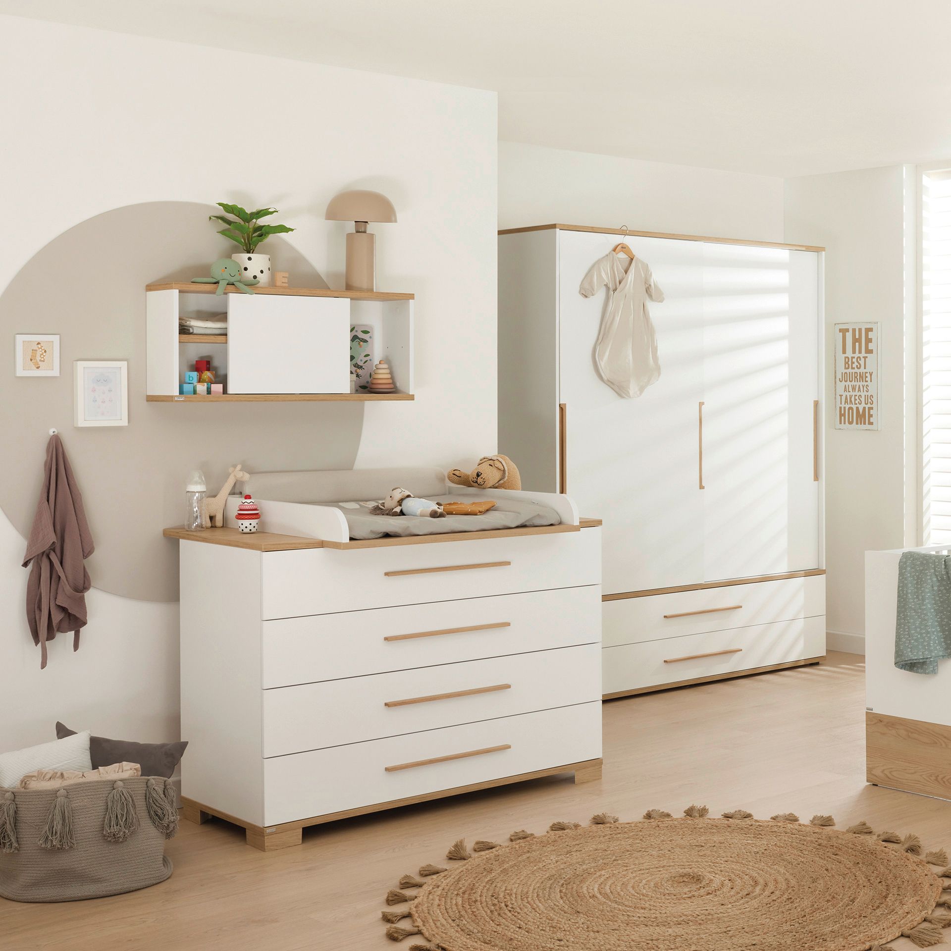 Modern, minimal nursery with white furniture, toys, and neutral decor accents.