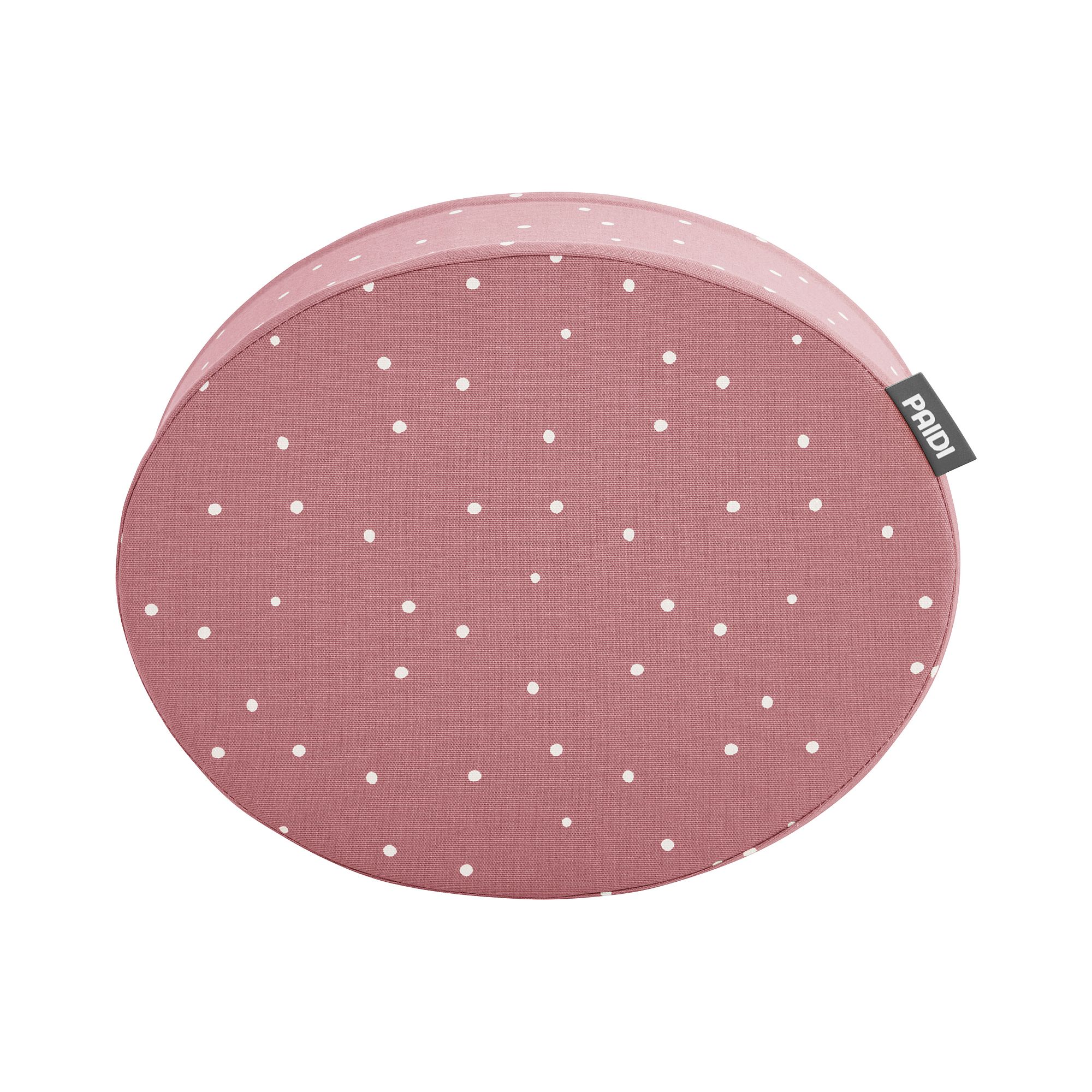 Rundes rosa Kissen mit weißen Tupfen und einem kleinen Stoffanhänger an der Seite.