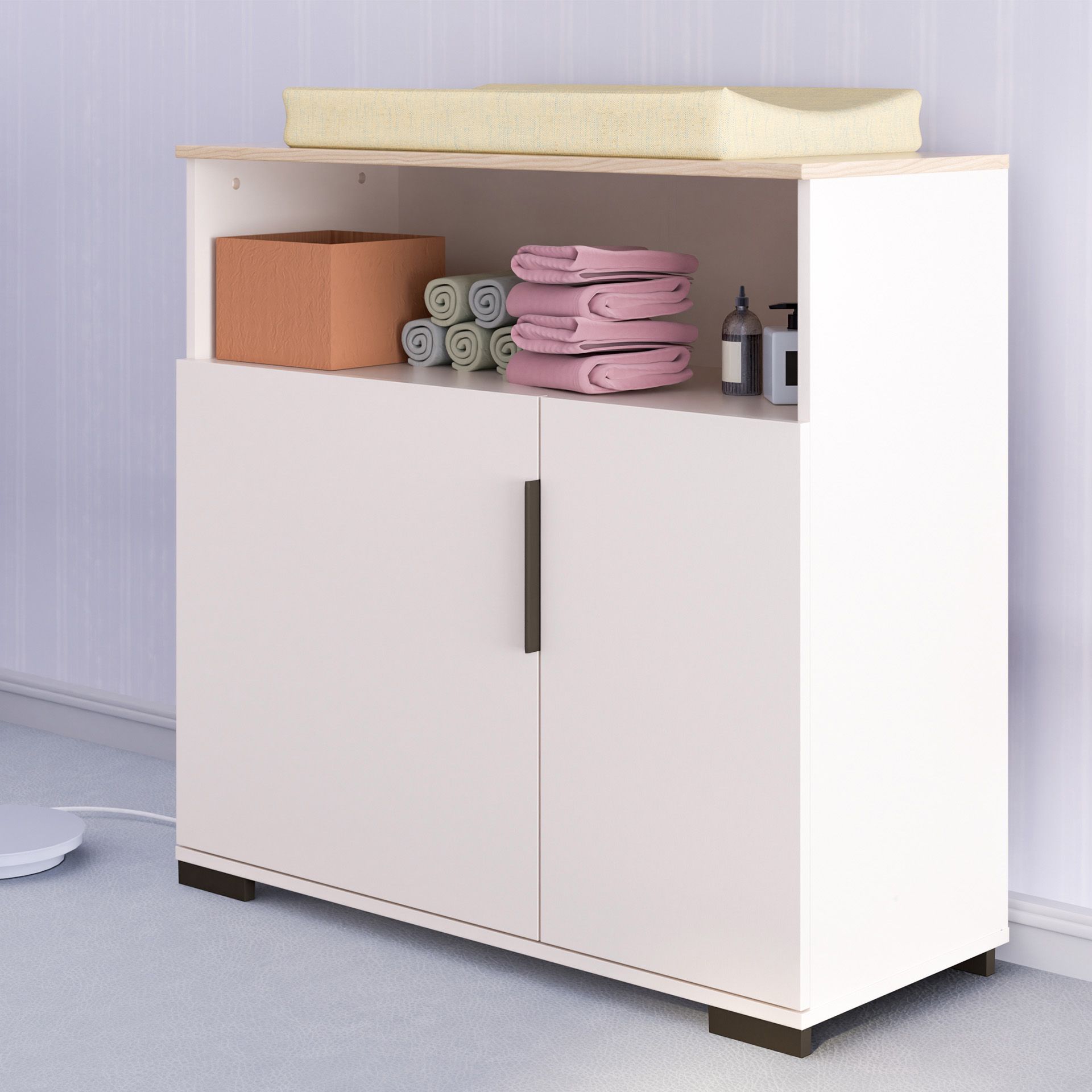 Wickelkommode Suzie mit 2 Türen und 1 offenen Fach Weißer Wickeltisch mit Ablagen für Handtücher, eine Box und Babyzubehör.
