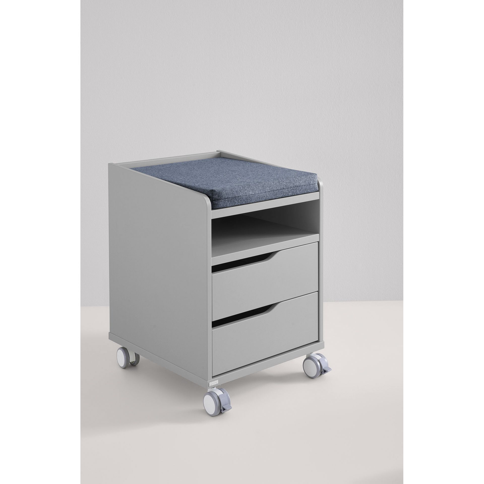 Gray rolling cabinet with two drawers and a blue cushioned top against a plain wall.