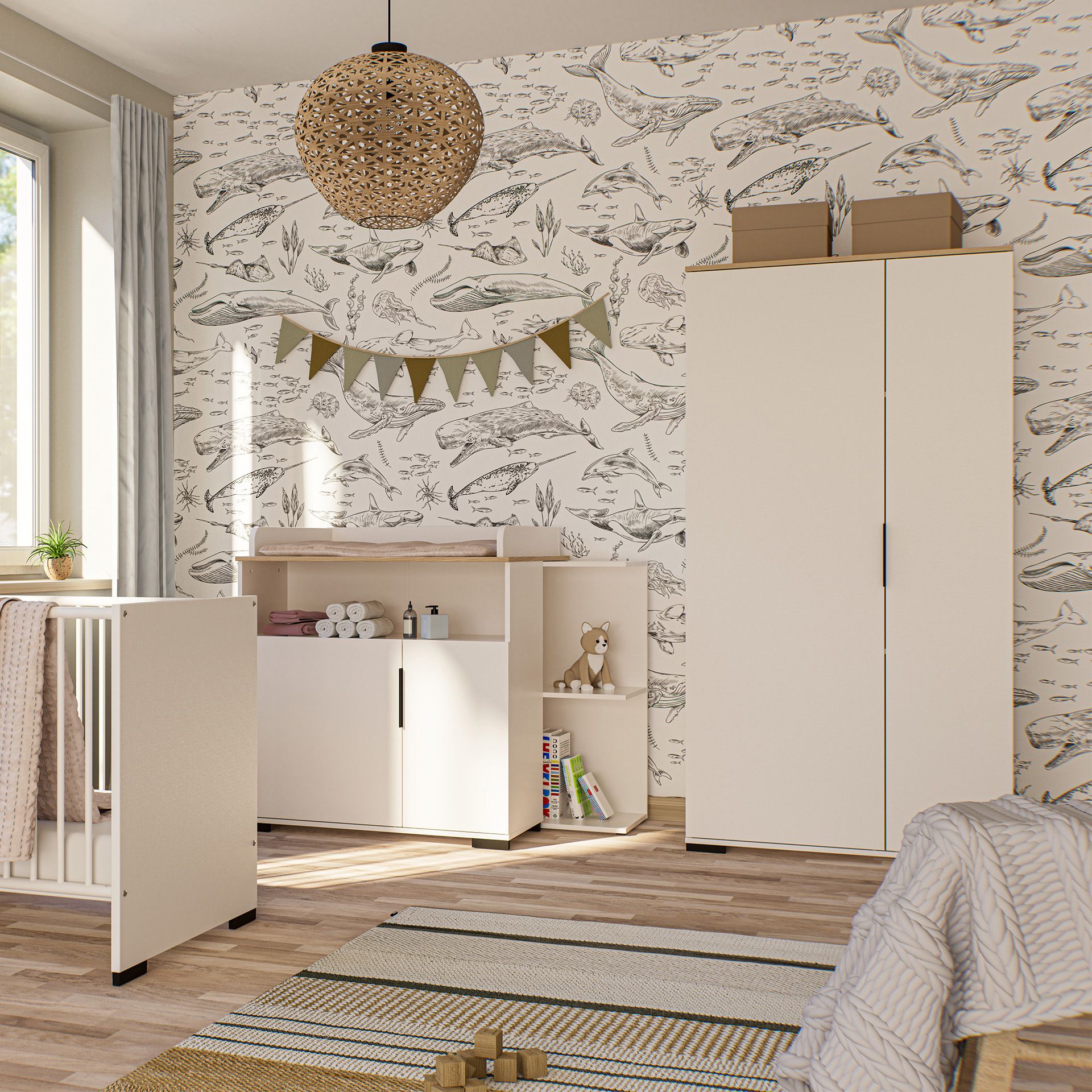 A cozy nursery with whale wallpaper, white furniture, and natural light.