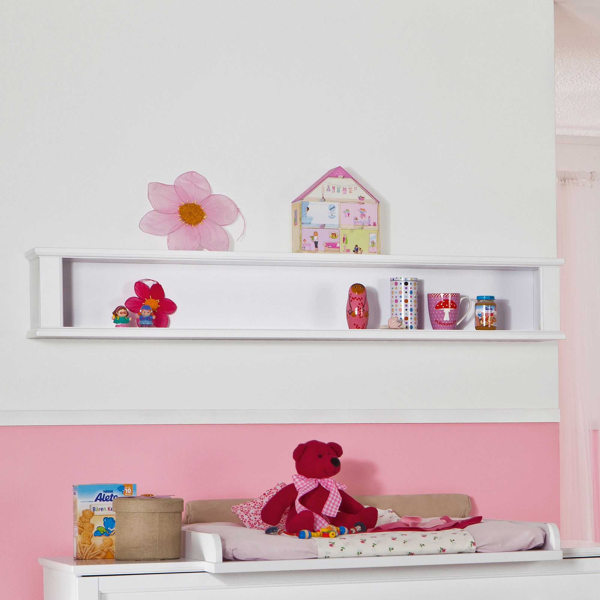 Wandregal Sophia mit 2 Böden in 144,3 cm Weißes Regal an einer rosafarbenen und weißen Wand mit Spielzeug, Büchern und Dekorationsgegenständen.